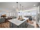 Open concept kitchen featuring a center island, pendant lights, and views of the living and dining areas at 14102 Night Owl Ln, Parker, CO 80134
