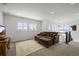 Cozy living room with plush seating, bright windows, and stylish staircase at 14102 Night Owl Ln, Parker, CO 80134