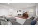 Bright living room with fireplace, hardwood floors, and a cozy sectional couch with neutral decor at 14102 Night Owl Ln, Parker, CO 80134