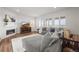 Bright living room featuring a fireplace, hardwood floors, and a cozy gray sectional couch at 14102 Night Owl Ln, Parker, CO 80134