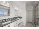 Modern main bathroom with double sinks, mosaic tile backsplash, and glass-enclosed shower at 14102 Night Owl Ln, Parker, CO 80134