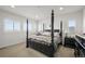 Luxurious main bedroom with a four-poster bed, plush bedding, and bright shuttered windows at 14102 Night Owl Ln, Parker, CO 80134