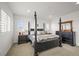 Bright main bedroom with a dark wood four-poster bed and classic decor at 14102 Night Owl Ln, Parker, CO 80134