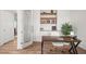 Office space featuring wood floors, open shelves, and large desk at 14102 Night Owl Ln, Parker, CO 80134