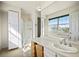 Bright bathroom with walk-in shower, storage cabinet, and large window at 1995 S Xanadu Way, Aurora, CO 80014