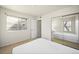 Bright bedroom featuring a mirrored closet, neutral walls, and a sunny window at 1995 S Xanadu Way, Aurora, CO 80014