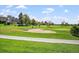 Beautiful view of the community golf course with lush green grass and mature trees on a sunny day at 1995 S Xanadu Way, Aurora, CO 80014