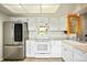 Bright kitchen featuring stainless steel refrigerator, white cabinets, and a window view at 1995 S Xanadu Way, Aurora, CO 80014