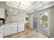 Bright kitchen with white appliances and sliding glass door to outdoor patio at 1995 S Xanadu Way, Aurora, CO 80014