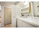 Efficient laundry room with modern washer and dryer, and ample storage shelves at 1995 S Xanadu Way, Aurora, CO 80014