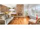 Cozy living room featuring a stone fireplace and built-in shelving at 1995 S Xanadu Way, Aurora, CO 80014