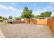 A large backyard featuring a gravel area and tall wooden fence, ideal for parking vehicles or other outside activities at 3638 N Elizabeth St, Denver, CO 80205