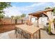 Backyard features a charming pergola-covered dining area and relaxing hammock, perfect for enjoying the outdoors at 3638 N Elizabeth St, Denver, CO 80205