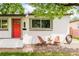 Charming home exterior with a bright red door and a cozy seating area at 3638 N Elizabeth St, Denver, CO 80205
