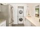 Convenient laundry area with stacked washer and dryer, and a butcher block counter at 3638 N Elizabeth St, Denver, CO 80205