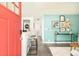 Inviting living room features light wood floors, aqua walls, and a stylish console table at 3638 N Elizabeth St, Denver, CO 80205