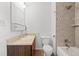 Well-maintained bathroom with modern fixtures, tiled shower, and wooden vanity for a functional design at 1188 S Troy St, Aurora, CO 80012