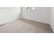 Bright bedroom featuring neutral carpet and a window letting in natural light at 1188 S Troy St, Aurora, CO 80012