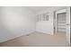 Bedroom with a window and carpet, next to a walk-in closet with built-in shelving at 1188 S Troy St, Aurora, CO 80012