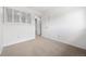 Bright bedroom featuring neutral carpet and a window, located near the entry door at 1188 S Troy St, Aurora, CO 80012