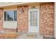 Close up of the front door, showing brickwork, front door and front window at 1188 S Troy St, Aurora, CO 80012