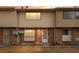 A brick and vinyl exterior of a townhome is captured at sunset, highlighting the unit number above the front door at 1188 S Troy St, Aurora, CO 80012