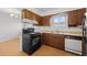 Traditional kitchen featuring wood cabinets, laminate counters, and an oven at 1188 S Troy St, Aurora, CO 80012