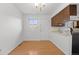 Open kitchen and dining area with matching laminate floors and classic finishes at 1188 S Troy St, Aurora, CO 80012