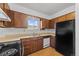 Traditional kitchen featuring wood cabinets, laminate counters, and a black refrigerator at 1188 S Troy St, Aurora, CO 80012