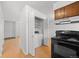 Kitchen area featuring a washer dryer closet and matching laminate floors at 1188 S Troy St, Aurora, CO 80012