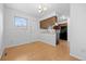 Open kitchen and dining area with matching laminate floors and traditional finishes at 1188 S Troy St, Aurora, CO 80012