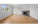 Bright living room with laminate flooring and a cozy fireplace providing an inviting space at 1188 S Troy St, Aurora, CO 80012