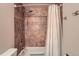 Bathroom with tub, shower, and patterned shower curtain at 1517 S Owens St # 7, Denver, CO 80232