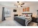 Spacious bedroom with king-size bed and ceiling fan at 1517 S Owens St # 7, Denver, CO 80232