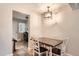 Bright dining area with table and chairs, view into entryway at 1517 S Owens St # 7, Denver, CO 80232