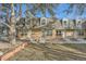 Front view of brick townhouses with a grassy yard at 1517 S Owens St # 7, Denver, CO 80232