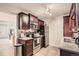 Galley kitchen with dark wood cabinets and granite countertops at 1517 S Owens St # 7, Denver, CO 80232