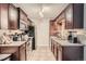 Well-equipped kitchen with dark wood cabinets and granite countertops at 1517 S Owens St # 7, Denver, CO 80232