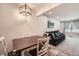 Living room features a dark sofa and a view of the dining area at 1517 S Owens St # 7, Denver, CO 80232