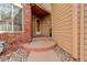 Welcoming front entrance with brick accents and mature landscaping adding charm to the home at 8101 E Dartmouth Ave # 22, Denver, CO 80231