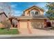 Two-story home featuring a brick and tan siding exterior with an attached two-car garage and manicured lawn at 8101 E Dartmouth Ave # 22, Denver, CO 80231