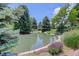 Scenic pond surrounded by mature trees, plants, and landscaping, offering a tranquil community setting at 8101 E Dartmouth Ave # 22, Denver, CO 80231