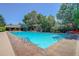Community pool surrounded by lush landscaping and comfortable lounge seating at 8101 E Dartmouth Ave # 22, Denver, CO 80231