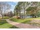 Gravel community walking path surrounded by trees and a view of the tennis courts at 8101 E Dartmouth Ave # 22, Denver, CO 80231