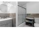 Bathroom featuring a sink with a granite vanity and walk-in shower with a frosted shower door at 18982 E 46Th Ave, Denver, CO 80249
