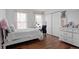Cozy bedroom with wood floors, closet, dresser, and two windows at 18982 E 46Th Ave, Denver, CO 80249