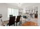 Dining area adjacent to a modern kitchen with an elegant chandelier at 18982 E 46Th Ave, Denver, CO 80249