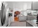 Well-lit kitchen boasts stainless steel appliances and gray cabinets at 18982 E 46Th Ave, Denver, CO 80249