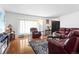 Bright living room with large windows, hardwood floors, and comfortable seating at 18982 E 46Th Ave, Denver, CO 80249