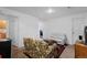Bright living room with cozy floral sofa, neutral seating, and a view of an adjoining room at 18982 E 46Th Ave, Denver, CO 80249
